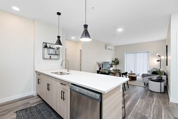 a kitchen with a white counter top and a stainless steel dishwasher